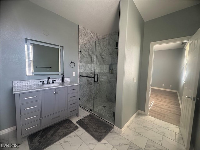 640 House Blend Ln, Henderson, NV 89052 - full bathroom with marble finish flooring, baseboards, vanity, and a marble finish shower