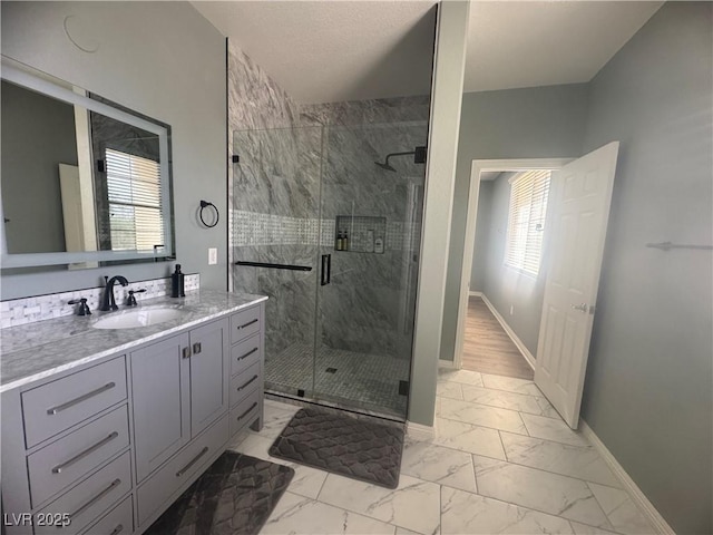 640 House Blend Ln, Henderson, NV 89052 - full bath featuring marble look tiles, a marble finish shower, and baseboards