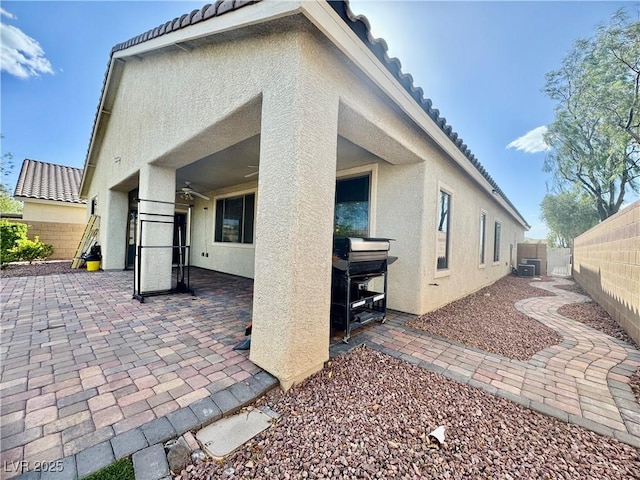 640 House Blend Ln, Henderson, NV 89052 - back of property with stucco siding, a patio, a tile roof, and a fenced backyard