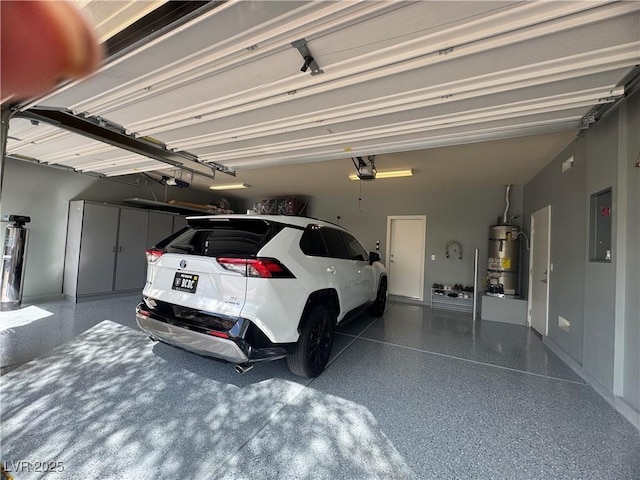 640 House Blend Ln, Henderson, NV 89052 - garage with strapped water heater, a garage door opener, electric panel, and baseboards
