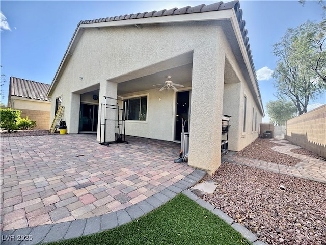640 House Blend Ln, Henderson, NV 89052 - back of house featuring stucco siding, a ceiling fan, a patio, a fenced backyard, and central AC unit