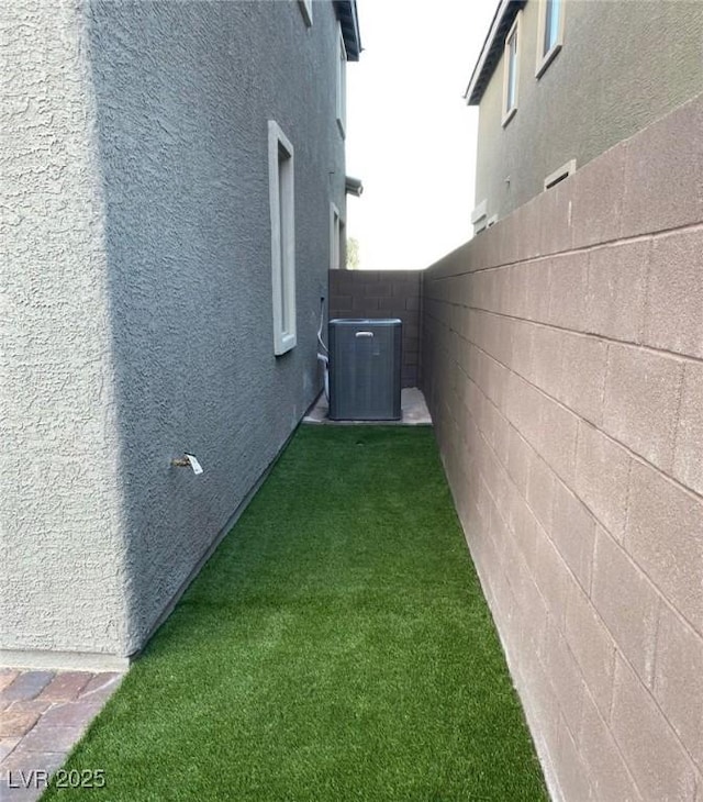 8021 Adelaide Hills St, Las Vegas, NV 89113 - view of side of home with stucco siding and central AC unit
