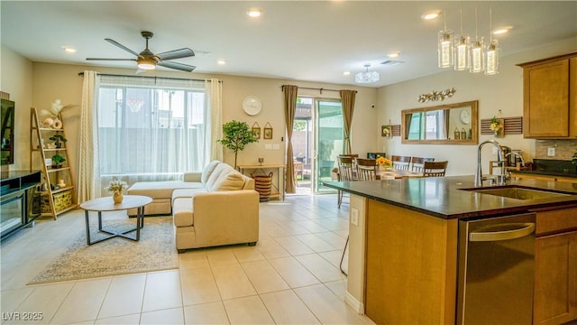 8021 Adelaide Hills St, Las Vegas, NV 89113 - kitchen with brown cabinetry, dark countertops, a sink, dishwasher, and a ceiling fan