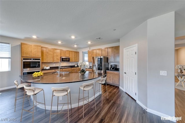 kitchen featuring stainless steel appliances, baseboards, dark countertops, dark wood-style flooring, and recessed lighting