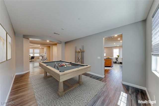 recreation room with pool table, wood finished floors, arched walkways, plenty of natural light, and recessed lighting
