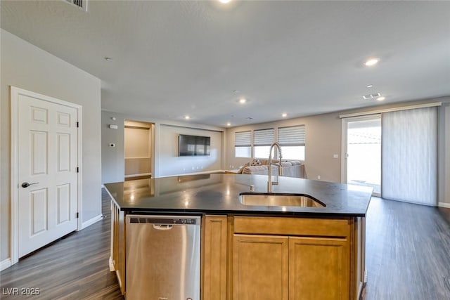 kitchen with a sink, dishwasher, dark countertops, open floor plan, and dark wood-type flooring