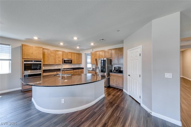 kitchen with stainless steel appliances, dark countertops, dark wood-type flooring, baseboards, and recessed lighting