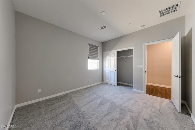 unfurnished bedroom featuring carpet flooring, baseboards, and a closet