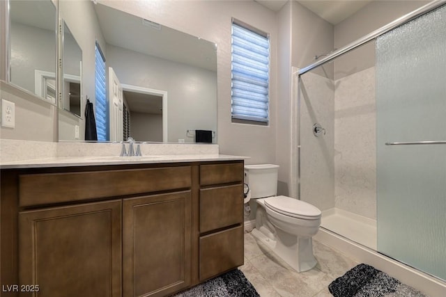 full bath featuring toilet, a stall shower, vanity, and tile patterned flooring