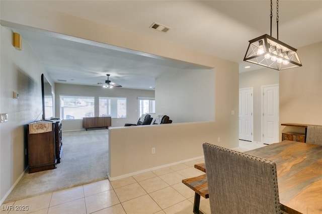 dining room featuring a ceiling fan, baseboards, light carpet, light tile patterned floors, and recessed lighting
