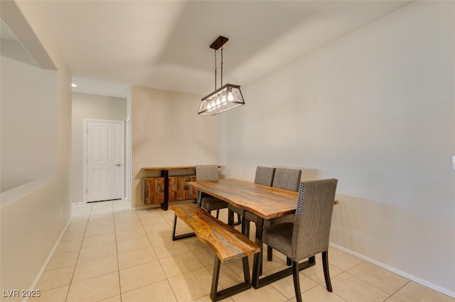 dining space with light tile patterned flooring and baseboards