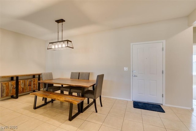 dining room with light tile patterned floors and baseboards