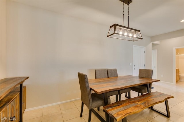 dining space with light tile patterned floors and baseboards
