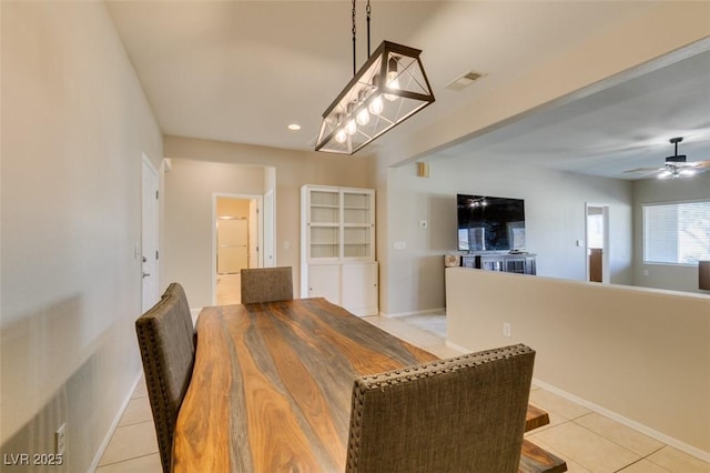 dining area with light tile patterned flooring, a ceiling fan, baseboards, and recessed lighting
