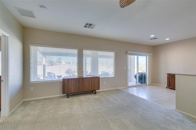 spare room with light colored carpet, a smoke detector, baseboards, recessed lighting, and light tile patterned floors