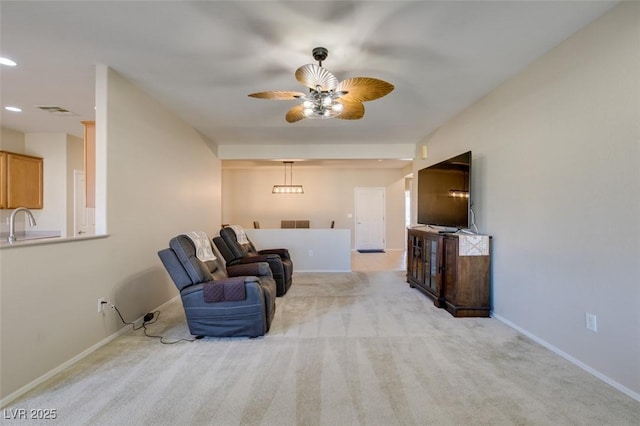 living area with a ceiling fan, recessed lighting, carpet, and baseboards