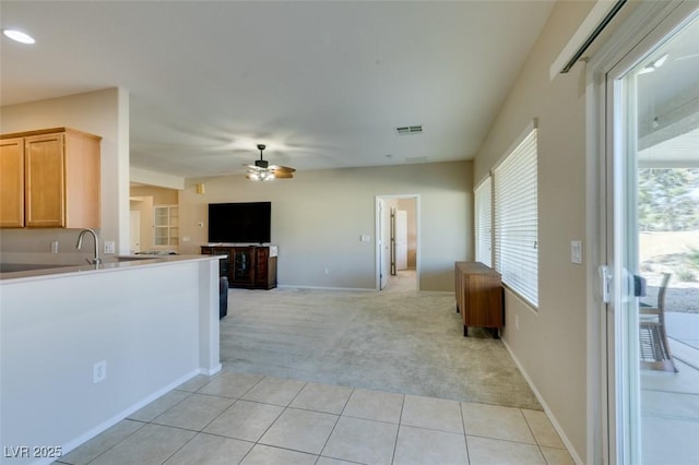 kitchen featuring ceiling fan, light colored carpet, plenty of natural light, open floor plan, and recessed lighting