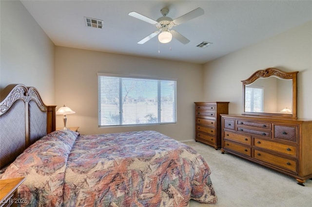 bedroom with multiple windows, light colored carpet, and ceiling fan
