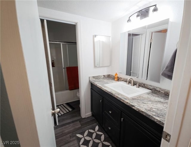 3771 Desert Marina Dr Unit 95, Laughlin, NV 89029 - bathroom featuring toilet, vanity, wood finished floors, a closet, and tub / shower combination