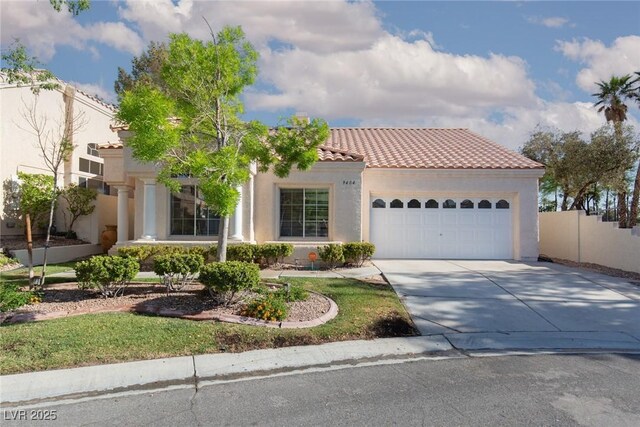 9404 Calico Garden Ave, Las Vegas, NV 89134 - mediterranean / spanish house with stucco siding, a tile roof, a garage, concrete driveway, and fence