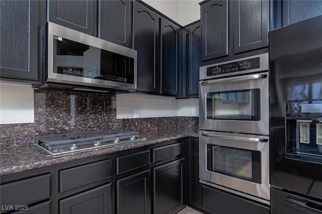 9404 Calico Garden Ave, Las Vegas, NV 89134 - kitchen with appliances with stainless steel finishes, dark stone counters, and backsplash