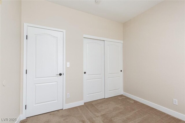 9404 Calico Garden Ave, Las Vegas, NV 89134 - unfurnished bedroom with light colored carpet, baseboards, and a closet