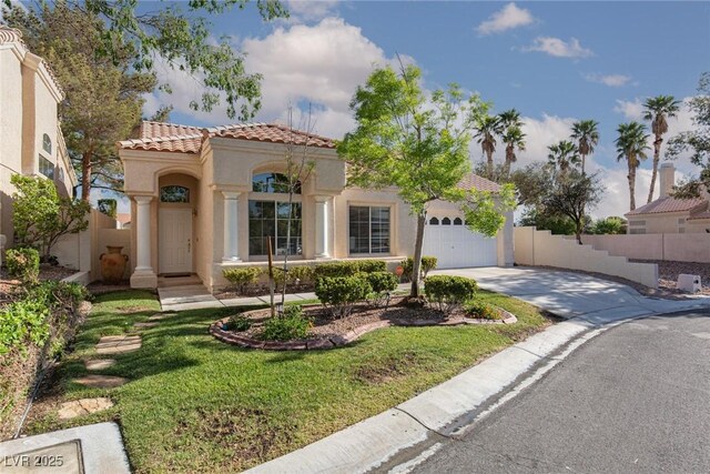 9404 Calico Garden Ave, Las Vegas, NV 89134 - mediterranean / spanish home featuring concrete driveway, a tile roof, stucco siding, and a garage
