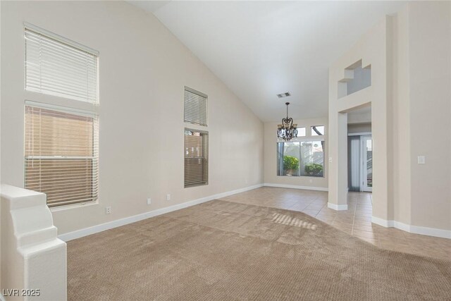 9404 Calico Garden Ave, Las Vegas, NV 89134 - unfurnished room featuring a chandelier, light colored carpet, light tile patterned flooring, baseboards, and high vaulted ceiling