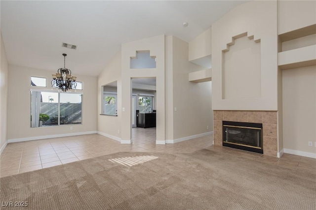 9404 Calico Garden Ave, Las Vegas, NV 89134 - unfurnished living room with a chandelier, light tile patterned floors, light carpet, a fireplace, and high vaulted ceiling