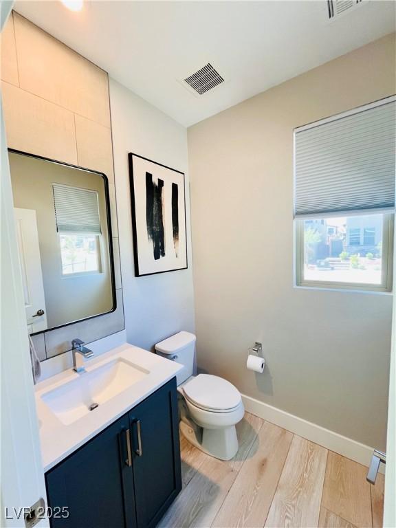 10280 Midnight Meteor Ave, Las Vegas, NV 89166 - bathroom featuring wood finished floors, vanity, toilet, and baseboards