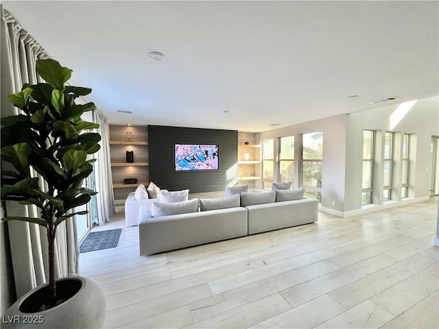 10280 Midnight Meteor Ave, Las Vegas, NV 89166 - living room with light wood-style floors and baseboards