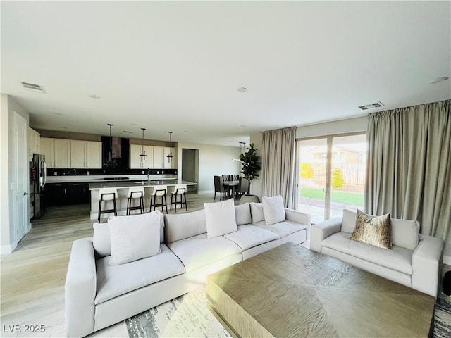 10280 Midnight Meteor Ave, Las Vegas, NV 89166 - living room featuring light wood-style flooring