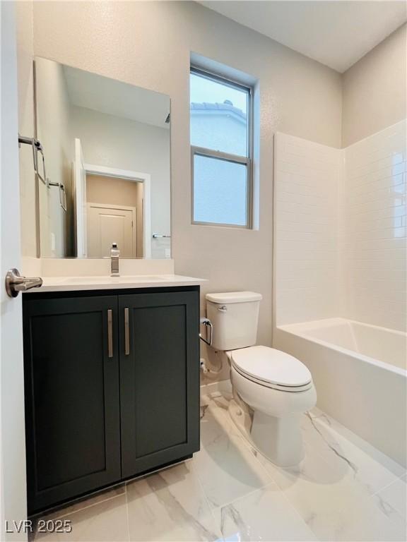 10280 Midnight Meteor Ave, Las Vegas, NV 89166 - full bathroom with toilet, vanity, marble finish flooring, and washtub / shower combination