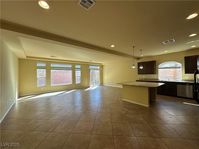 kitchen with open floor plan, a kitchen island, tile patterned flooring, baseboards, and recessed lighting