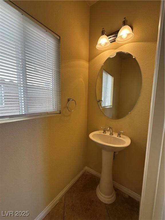 bathroom featuring tile patterned flooring and baseboards