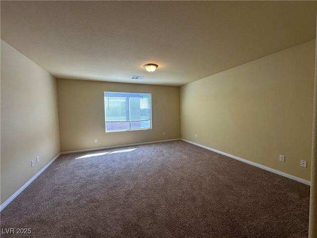 carpeted empty room with baseboards