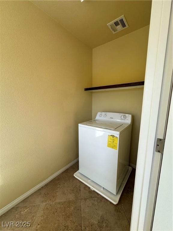 laundry area featuring washer / dryer and baseboards