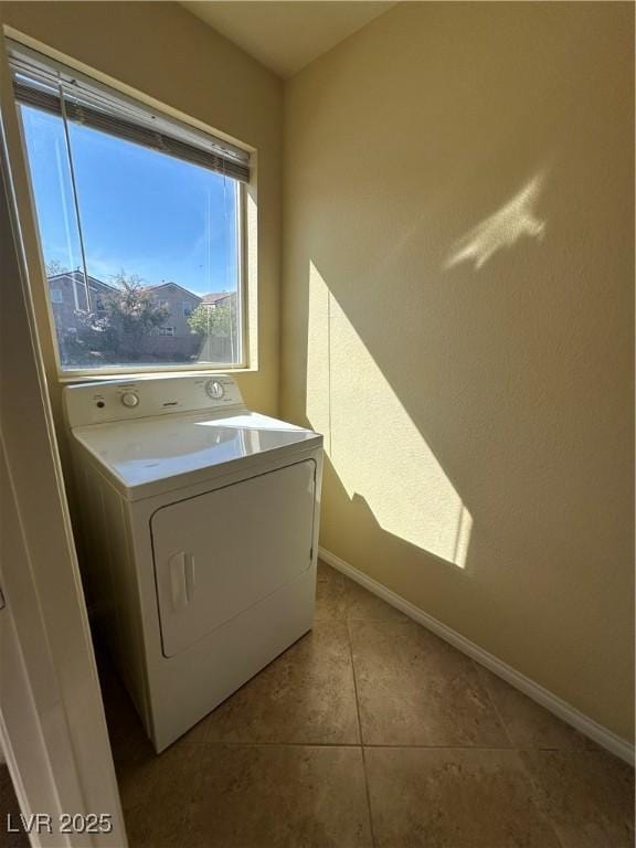 washroom with washer / clothes dryer, baseboards, and tile patterned flooring