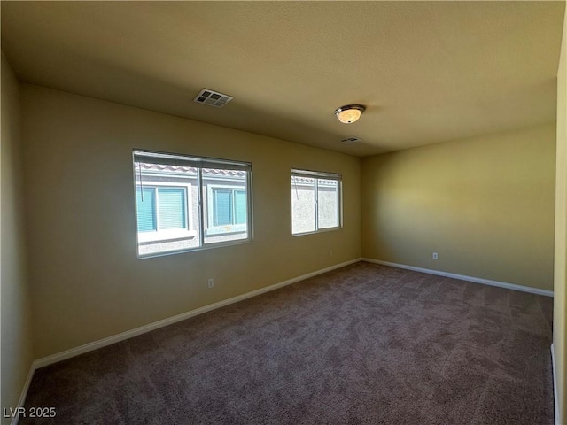 carpeted empty room with baseboards