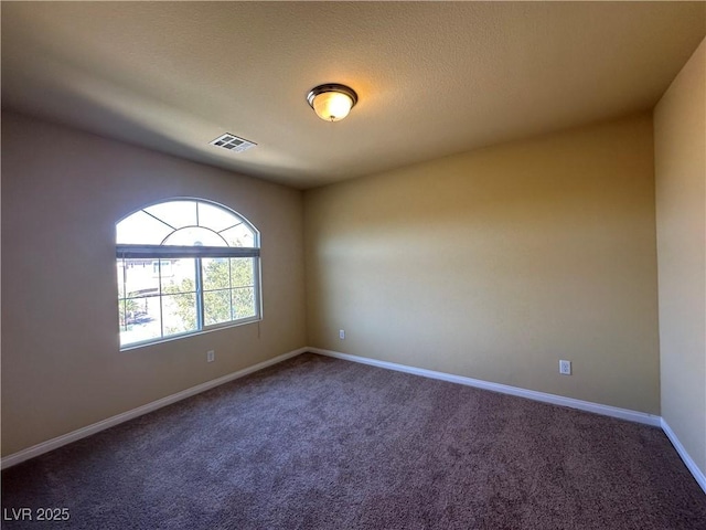 unfurnished room with carpet floors and baseboards