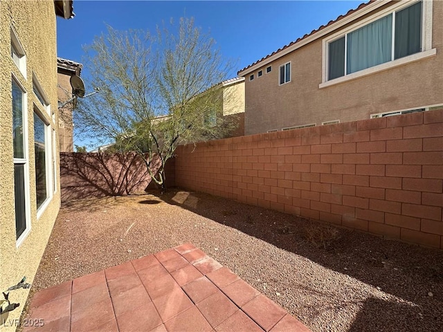 fenced backyard featuring a patio area