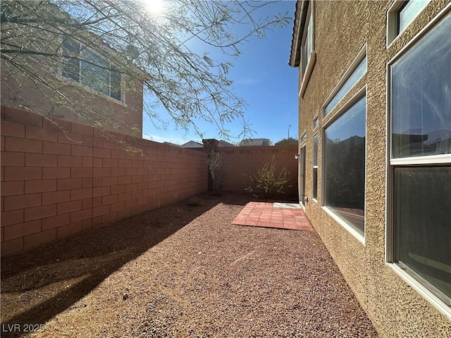 fenced backyard with a patio