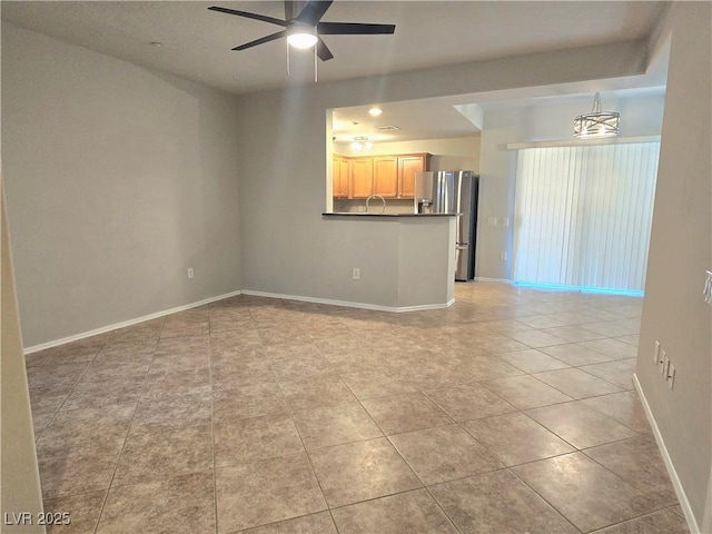 4675 Basilicata Ln Unit 103, North Las Vegas, NV 89084 - unfurnished living room with a ceiling fan, baseboards, and light tile patterned flooring