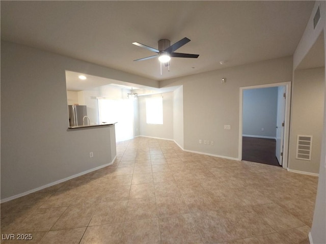 4675 Basilicata Ln Unit 103, North Las Vegas, NV 89084 - unfurnished living room featuring a ceiling fan, light tile patterned floors, and baseboards
