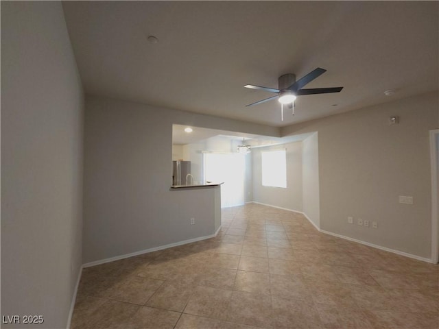 4675 Basilicata Ln Unit 103, North Las Vegas, NV 89084 - unfurnished room with ceiling fan, light tile patterned flooring, and baseboards