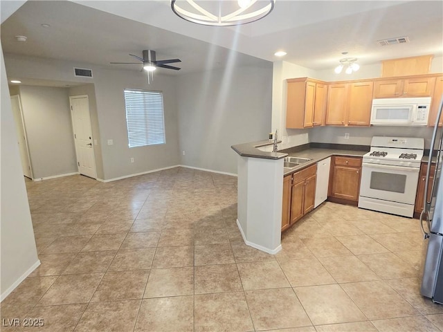 4675 Basilicata Ln Unit 103, North Las Vegas, NV 89084 - kitchen with white appliances, a sink, dark countertops, light tile patterned flooring, and baseboards