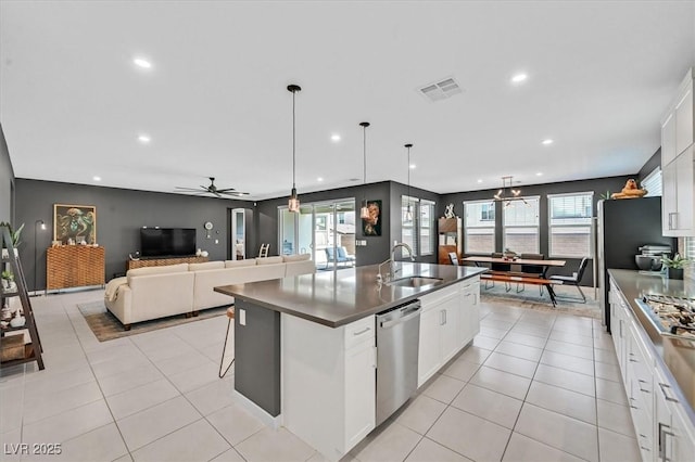6834 Fallen Rock St, North Las Vegas, NV 89084 - kitchen featuring stainless steel appliances, a sink, dark countertops, recessed lighting, and a kitchen island with sink