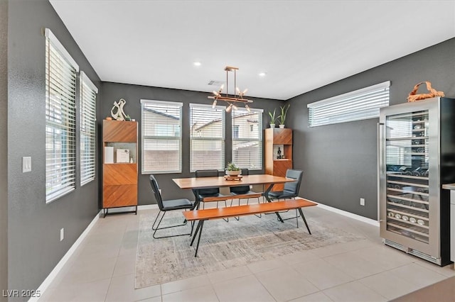 6834 Fallen Rock St, North Las Vegas, NV 89084 - dining room with beverage cooler, a chandelier, baseboards, recessed lighting, and light tile patterned floors