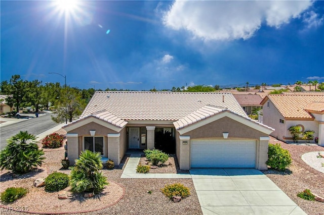 10301 Coal Creek Pl, Las Vegas, NV 89134 - ranch-style house featuring an attached garage, a tile roof, concrete driveway, and stucco siding
