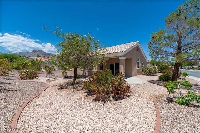 10301 Coal Creek Pl, Las Vegas, NV 89134 - rear view of property with stucco siding, a mountain view, and a tiled roof